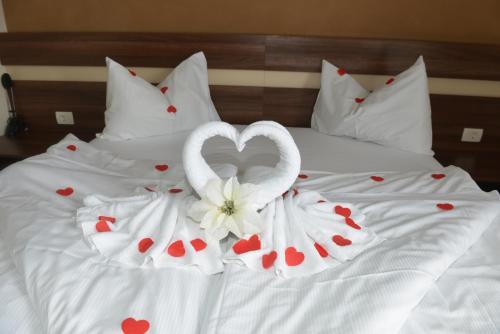 two swans made out of hearts on a bed at Primus Hotel & Apartments in Vienna