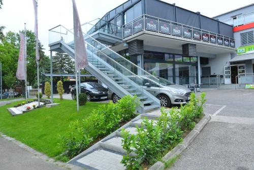 a car parked in a parking lot in front of a building at Primus Hotel & Apartments in Vienna