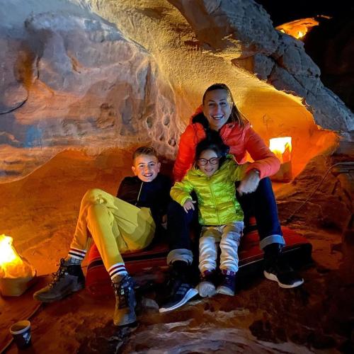 a group of people sitting in a cave at Wadi Rum Dream Camp in Wadi Rum
