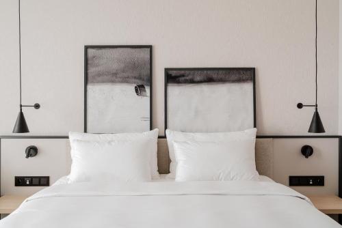 a bedroom with two beds with white pillows at Radisson Resort Kołobrzeg in Kołobrzeg