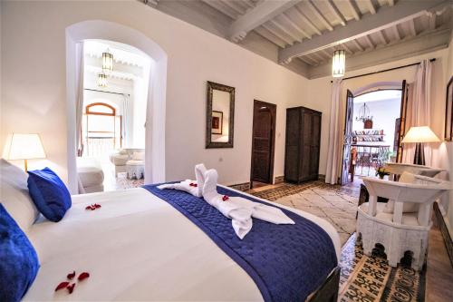 a bedroom with a large bed with towels on it at Villa Garance in Essaouira