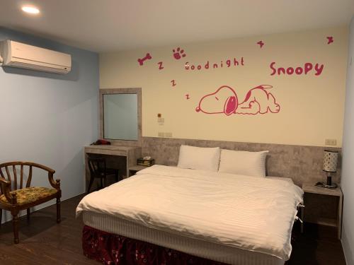 a bedroom with a bed and a desk and a mirror at Grandma Yu's B&B in Yuchi