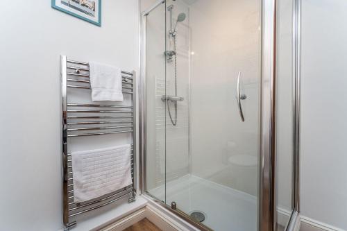a bathroom with a shower with a glass shower stall at Alban Rise in Keswick