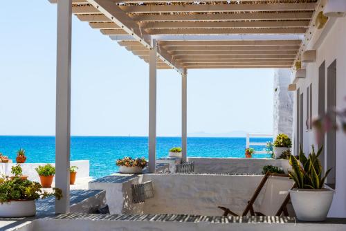 a patio with a view of the ocean at Ammos Sifnos Village in Platis Gialos