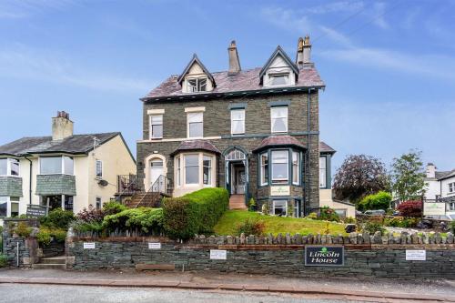 a large brick house with a sign in front of it at The Ridgeway in Keswick