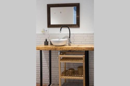 a bathroom with a counter with a sink at La casa de las barcas Suite a pie de playa in Calafell