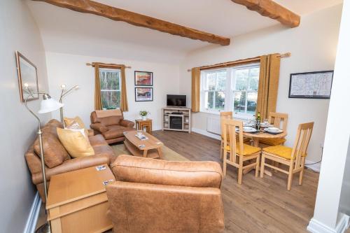 a living room with a couch and a table at Lake View Cottage in Braithwaite