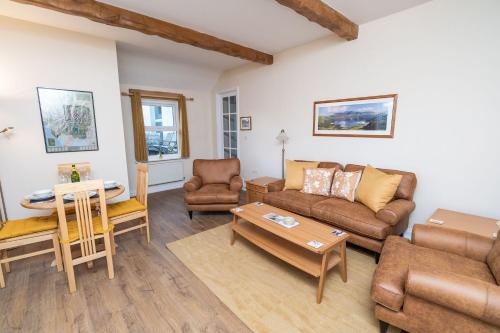 a living room with a couch and a table at Lake View Cottage in Braithwaite