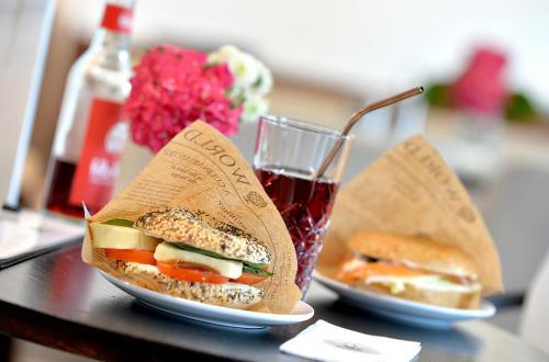 two sandwiches on a table with a glass of soda at Hotel Zehnthof in Cochem