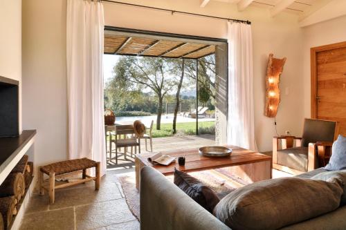 a living room with a couch and a table at Domaine de Peretti della Rocca in Figari