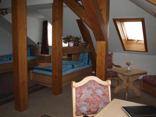 a bedroom with two bunk beds and a table at Gasthof zur Schweiz in Jena
