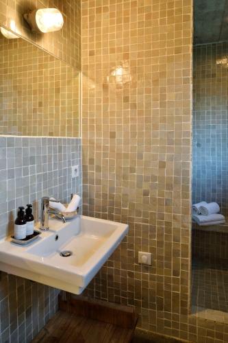 a bathroom with a sink and a mirror at Domaine de Peretti della Rocca in Figari