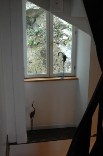 a window in a room with two vases on a shelf at Domfront - Numero CINQ in Domfront