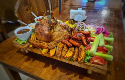 a tray of food with a chicken and vegetables on a table at Chveni sakhli in Tbilisi City