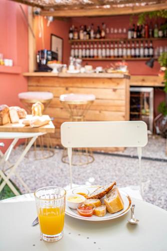 a plate of food on a table with a glass of orange juice at toctoctoc lisboa in Lisbon