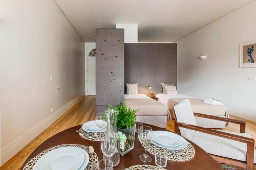 a living room with a table and a couch at bnapartments Loftpuzzle in Porto