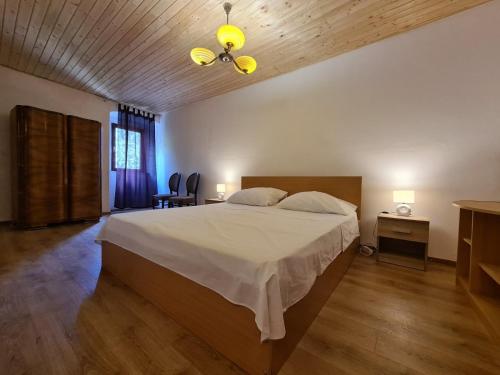 a bedroom with a large bed and a wooden floor at House Krnica 2120 in Krnica