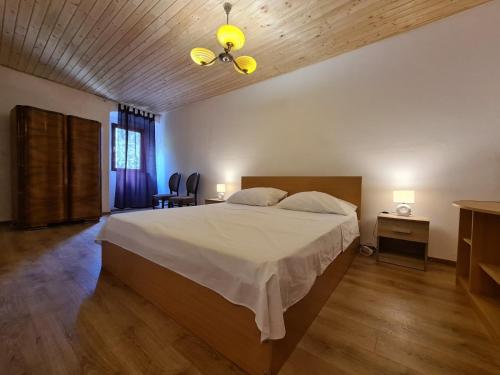 a bedroom with a large bed and a wooden floor at House Krnica 2120 in Krnica