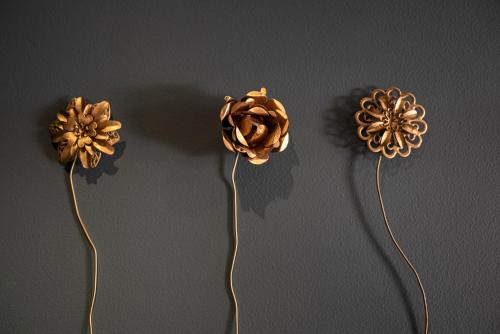two fake flowers on a wall with their shadows at toctoctoc lisboa in Lisbon