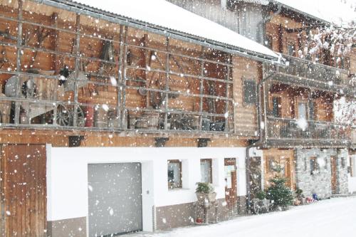 a snow covered building with a garage at Ledererhof in Aschau