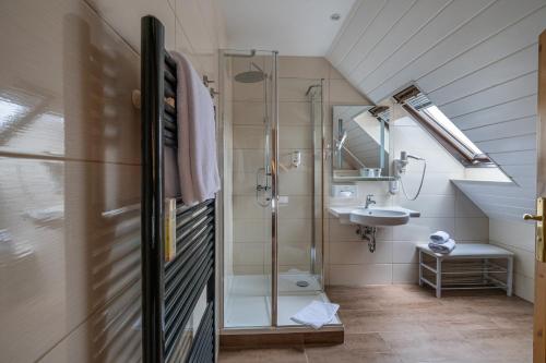 a bathroom with a shower and a sink at Am Anger in Wernigerode