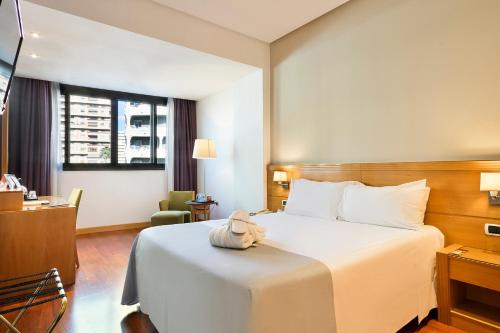 a hotel room with a large bed and a large window at Hotel Málaga Alameda Centro Affiliated by Meliá in Málaga