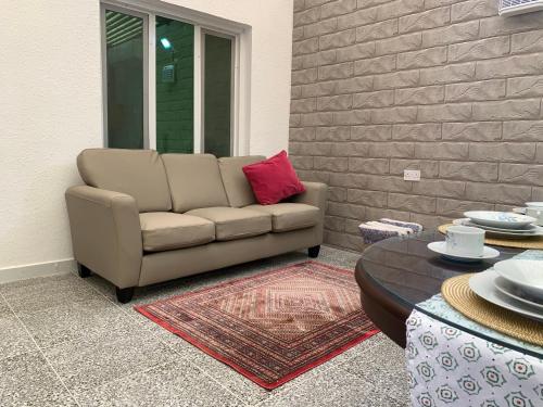 a living room with a couch and a table at Oriental Nights Rest House in Al Wāşil