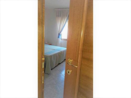 a door leading to a bedroom with a bed at Costa vacanze in low cost - IUN P2923 in Villaputzu