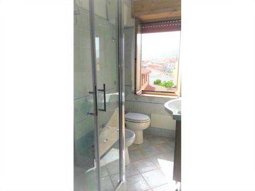 a bathroom with a toilet and a sink and a window at Costa vacanze in low cost - IUN P2923 in Villaputzu