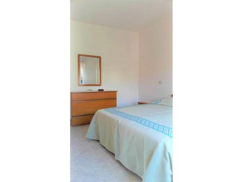 a bedroom with a bed with a dresser and a mirror at Costa vacanze in low cost - IUN P2923 in Villaputzu