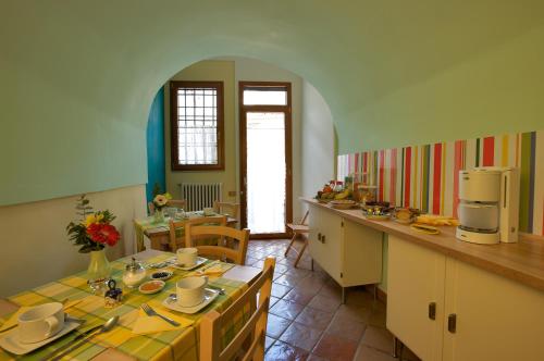 a kitchen with a table and chairs in a kitchen at La Casa di Donn'Amelia in Vietri sul Mare