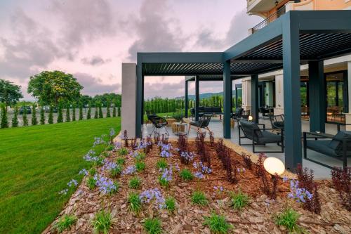 a garden with purple flowers in a yard at Green Life Sozopol Antares in Sozopol