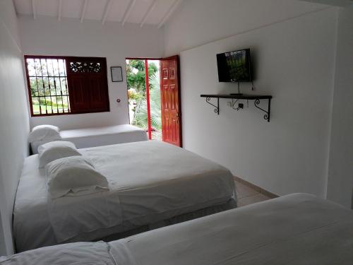 Un pat sau paturi într-o cameră la Finca Hotel Santana Campestre
