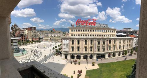 a large white building with a sign on top of it at Square Vanilla Apartments in Skopje