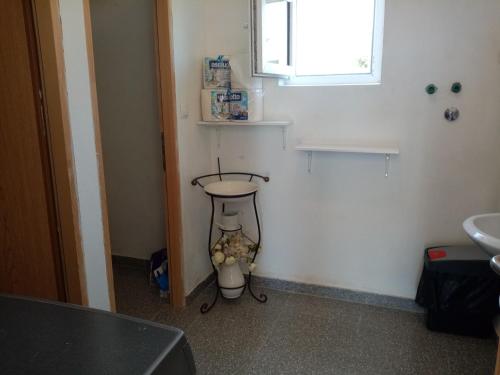 a small bathroom with a sink and a window at CAMPING LASTE in Smoković