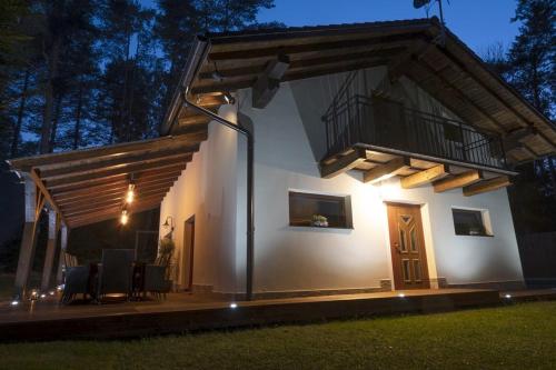 a house with a balcony on the side of it at Chata Emily in Smižany