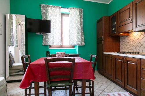 a kitchen with a table with a red table cloth at Monolocale il Tindaro in Catania