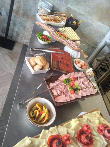 a table topped with lots of different types of food at Motel BTG in Tomislavgrad