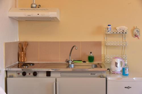 a kitchen with a sink and a counter top at Petrakis Sea View in Palaiochóra