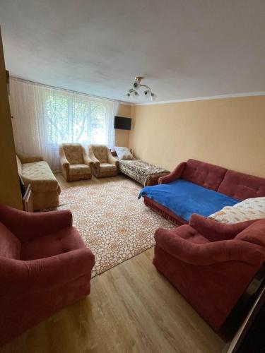 a living room with a couch and a bed at Приватна садиба Велятин in Velyatyn