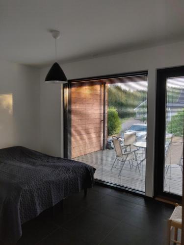 a bedroom with a bed and a view of a patio at Villa Gardens in Imatra