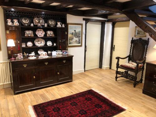a living room with a table and a chair at Picket Post House Bed & Breakfast in Catterall