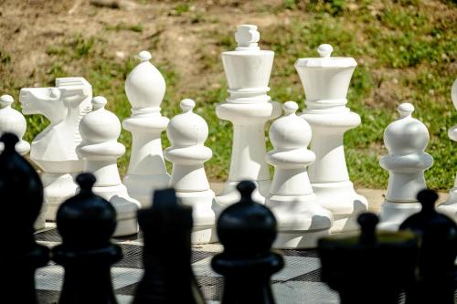 a group of white chess pieces on a table at JUFA Hotel Maria Lankowitz in Maria Lankowitz
