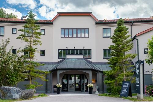 a large white building with an entry way at JUFA Hotel Maria Lankowitz in Maria Lankowitz