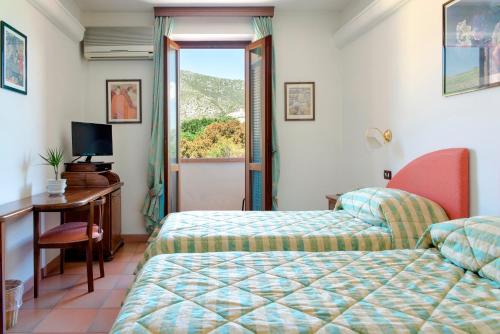 Säng eller sängar i ett rum på Hotel Ristorante da Carlos