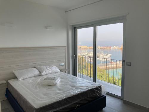een slaapkamer met een bed en een groot raam bij Residenza Timpa Janca in Vibo Valentia Marina