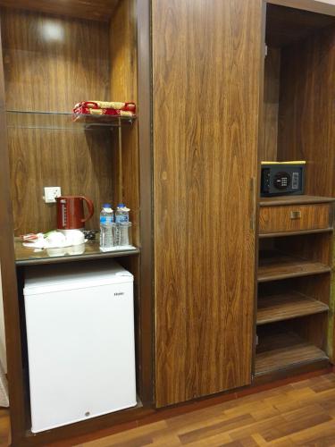 a kitchen with a small refrigerator in a room at S Chalet Islamabad in Islamabad