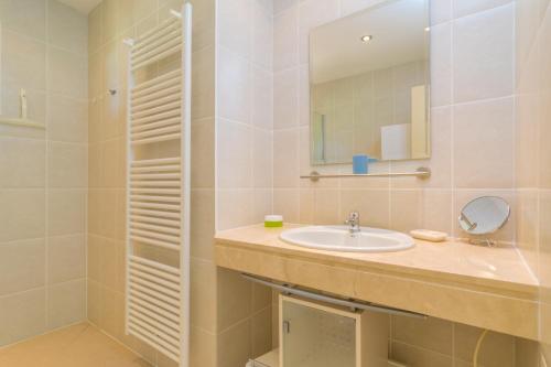 a bathroom with a sink and a mirror at Can Clavell in Artá
