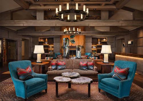 a living room with a couch and two chairs at Little America Hotel Flagstaff in Flagstaff