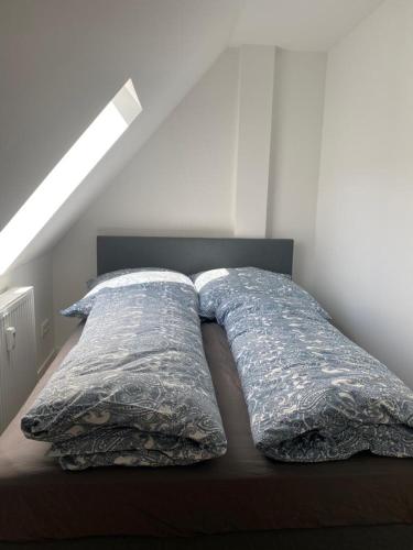 a bed with two pillows on it in a room at city roof in Teterow